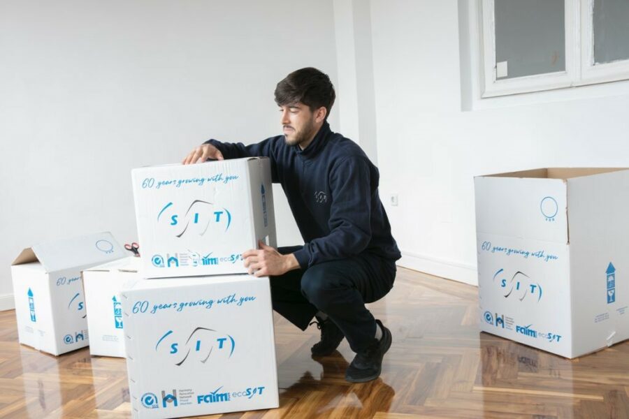 A couple wrapping possessions following the ways to pack your belongings for an international move