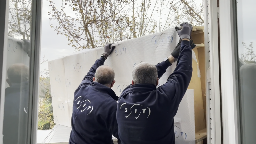 A couple wrapping possessions following the ways to pack your belongings for an international move